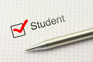 Student questionnaire choice. Educational survey. Occupation concept. Marked checkbox with a silver pen on paper background.