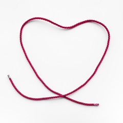 Heart shape from red yarn,rope on blue background.love,wedding,valentine concept