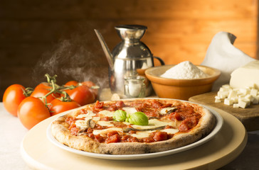 Obraz na płótnie Canvas Pizza with ingredients on the table