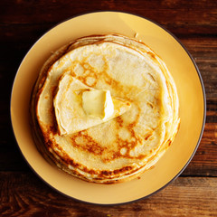 Stack of Russian-style pancakes with raspberries