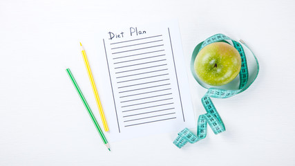 Food  diet concept,Plan. Green Apple Notepad on a White Background.Healthy Beverage.Vegetarian.Copy space for Text. selective focus.
