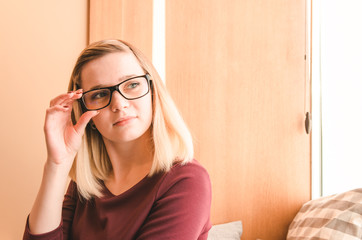 Relaxed young woman in eyeglasses