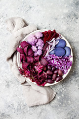 Obraz na płótnie Canvas Purple Buddha bowl with spiral carrots, cauliflower, beet, onion, potato, shredded red cabbage, radicchio salad, kalamata olives. Vegan detox veggie bowl