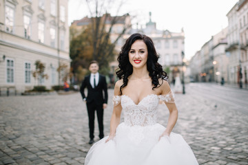 Bride and groom walking through the old town