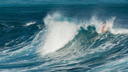 MAUI, HAWAII, USA - DECEMBER 10, 2013: Surfers are riding waves at hookipa beach