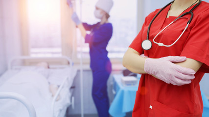 concept healthcare medicine. Doctor red suit stethoscope patient's background hospital.
