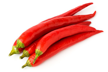 A bunch of red chili peppers on a white.