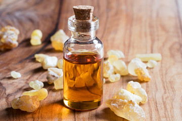 A bottle of frankincense essential oil with frankincense crystals