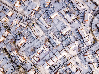 Aerial view of snow covered traditional housing suburbs in England. Snow, ice and adverse weather conditions bring things to a stand still in the housing estates of a British suburb