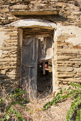 Fototapeta premium Ruins of an old house, broken door