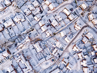 Aerial view of snow covered traditional housing suburbs in England. Snow, ice and adverse weather...