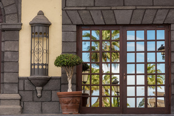 Fototapeta na wymiar Mirrored window on a patio door of a mediterranean house