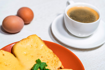 Breakfast of cheese sandwich, eggs and coffee