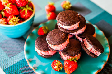 Stacked Homemade Strawberry Ice-Cream Sandwiches, Chocolate Cookies, Bowl of Strawberries