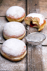 Traditional Polish donuts on wooden powder. Tasty doughnuts with jam.