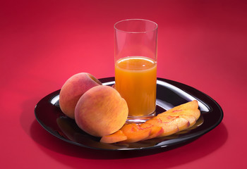 Fresh ripe peaches on a beautiful red background.