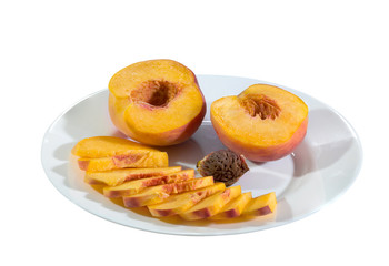 Ripe peaches in a white plate on a white background.