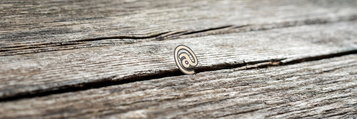 Small web address At icon on rustic wood