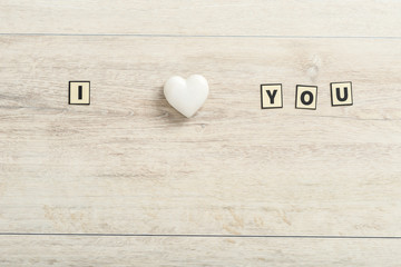 Romantic I Love You message on wood with a marble heart