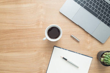 Minimal work space - Creative flat lay photo of workspace desk. Top view office desk with laptop, notebooks, coffee cup copy space on wooden background. Top view with copy space, flat lay photography.