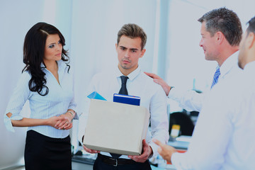 dismissed businessman carrying box.