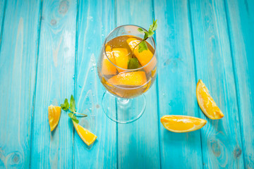 Negroni cocktail with an orange on blue wood table