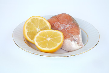 lemon and salmon on porcelain plate