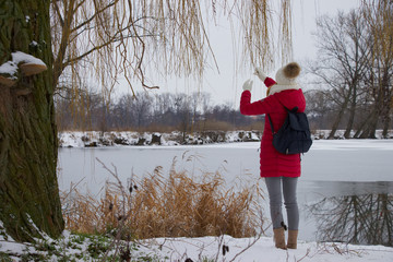 traveler girl standing at riverside in winter season