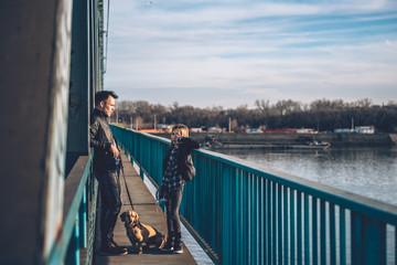 Father and daughter standing on the bridge and having conversation