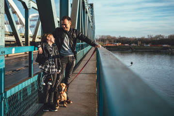 Father and daughter standing on the bridge and talking