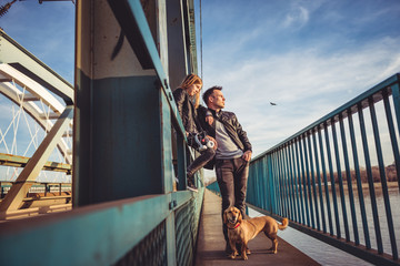 Father and daughter resting on the freight bridge