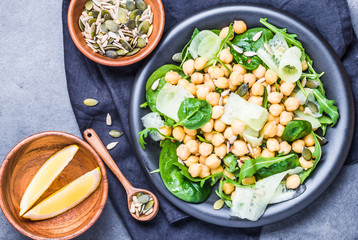 Chickpea salad with greens and seeds top view.Healthy vegetarian food plate.