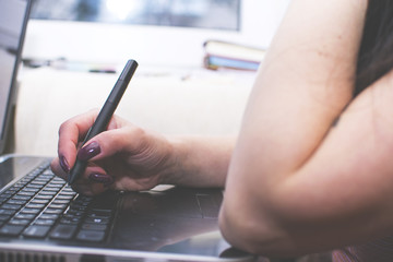 The girl works at the computer. Decorator. Manager. Close up.