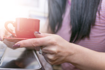 Girl drinking coffee in front of the computer. Interval.