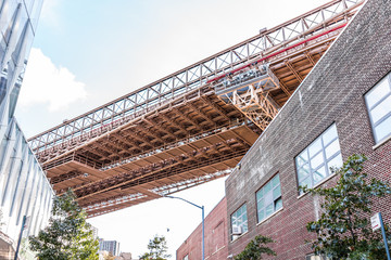 Closeup isolated view of under Manhattan Bridge in Brooklyn outside exterior outdoors in NYC New York City, brick buildings