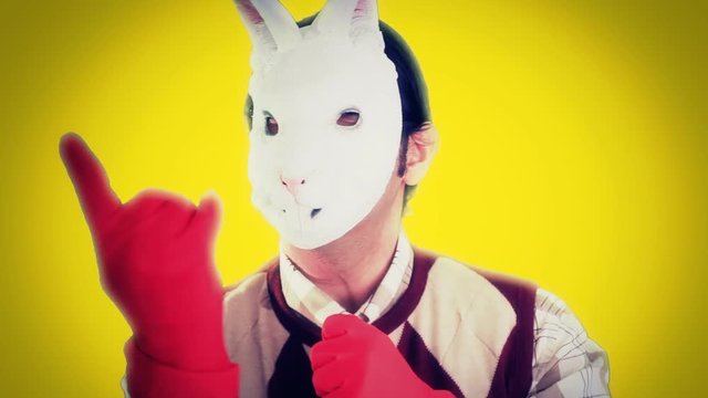 A scary ugly nerd wearing a bunny mask and red gloves, inviting the viewer with his finger.
