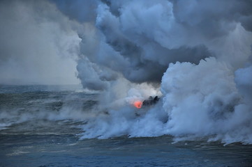 The hot lava of the Hawaiian volcano Kilauea flows into the waters of the Pacific Ocean