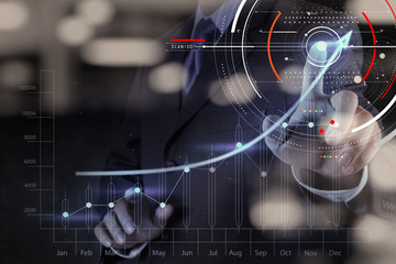 Concept of focus on target with digital diagram,graph interfaces,virtual UI screen,connections netwoork.Hipster finance analist working at trendy office
