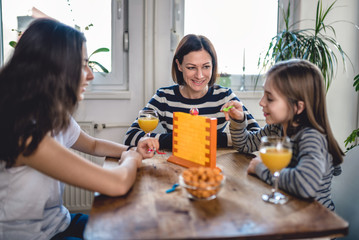 Family playing board games at home