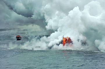 The hot lava of the Hawaiian volcano Kilauea flows into the waters of the Pacific Ocean