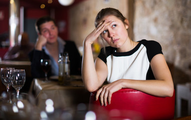 woman sitting apart in restaurant with drunk man