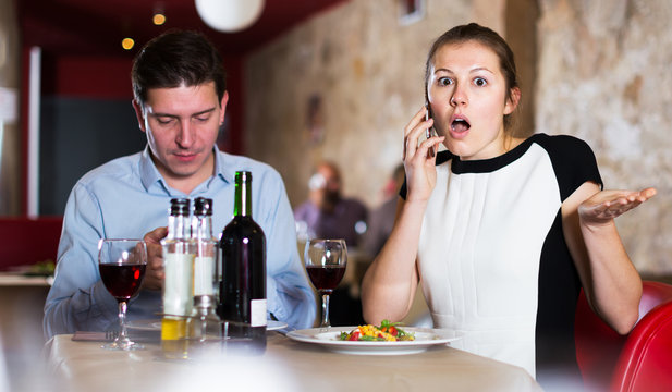 Couple with phones at restaurant