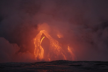 The hot lava of the Hawaiian volcano Kilauea flows into the waters of the Pacific Ocean