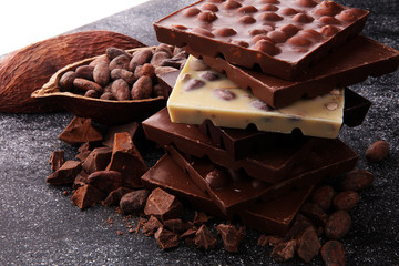 Chocolate bars on dark background with chocolate tower