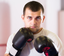 Portrait of boxer which is practicing different kiks