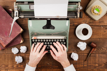 businessman hands writing on an old typewriter
