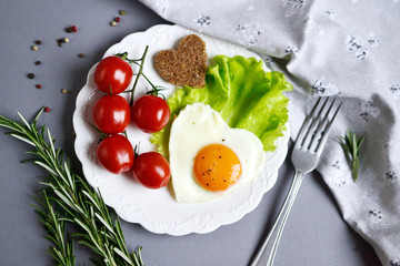 Tasty Fried Egg in the Shape of a Heart Served on a White Plate Rosemary Tomato Salad Leaves Grey Background Valentine Day Morning