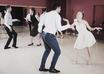 Dancing couples enjoying active dance