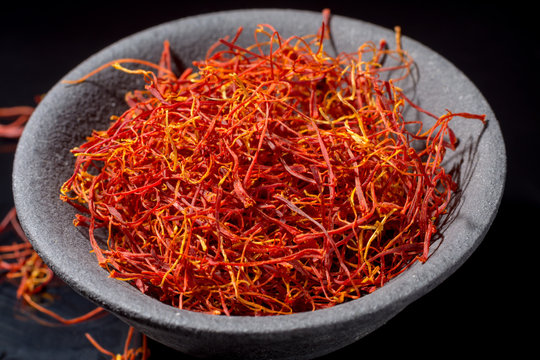 Macro collection, expensive real dried red saffron spice close up on black