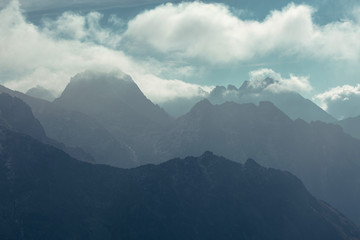 Obraz premium Mountain peaks in Tatra mountains and fog. Photography in pastel colors.